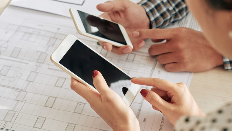 Hands of business people checking messages in their smartphones